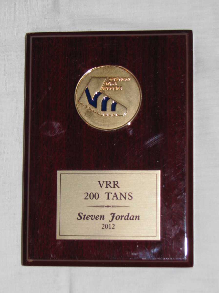 Steve Jordan Remembrance
When Steve Jordan (C58) died in late 2014, we were lucky enough to get this keep sake for our club records. As Steve was an avid fun runner, it was perhaps fitting that the shield we have was awarded to him in 2012 to recognise his feat in completing his 200th monthly Tan run with the Victorian Road Runners.

